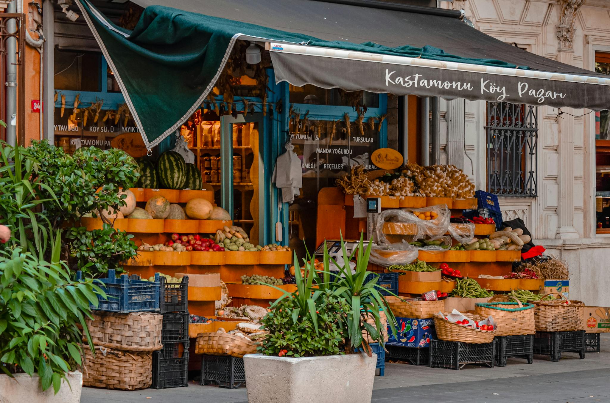 Colorful market stall displaying a variety of fresh fruits and vegetables.